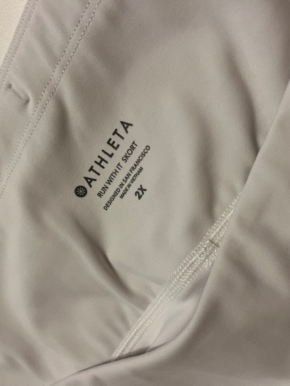 Athleta "Run With It Skort" in white, size 2X